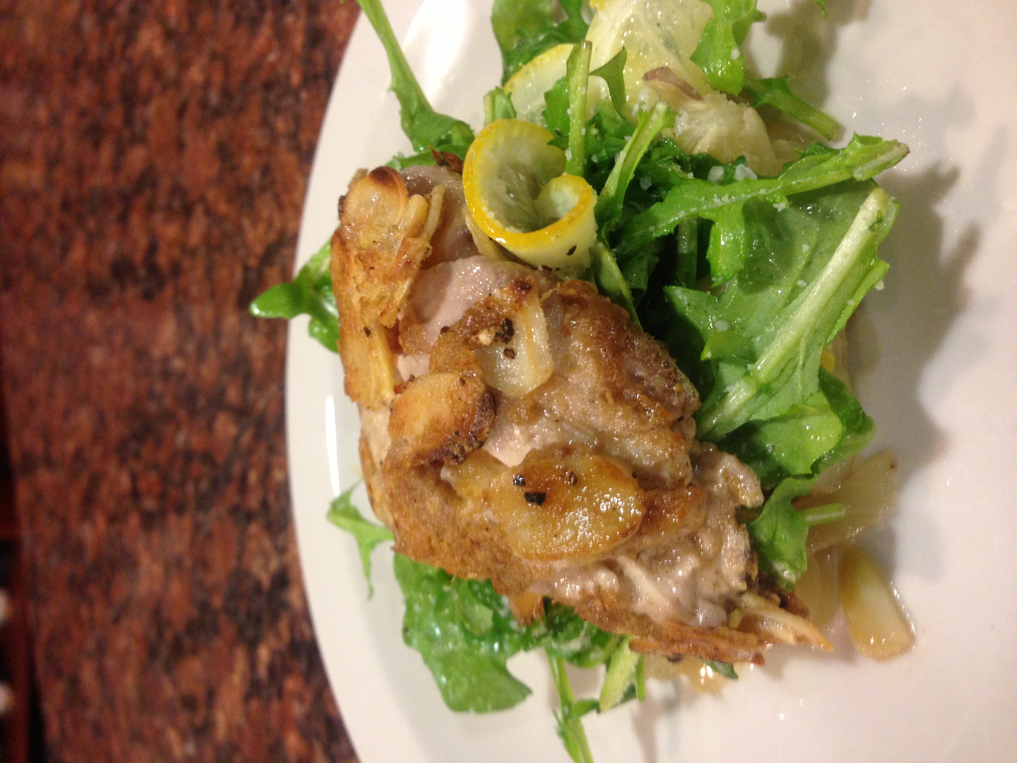 Crispy fried veal brain on arugula with lemon slices