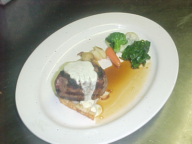 Grilled beef filet with Gorgonzola fondue, demi-glace, roasted potatoes and seasonal vegetables