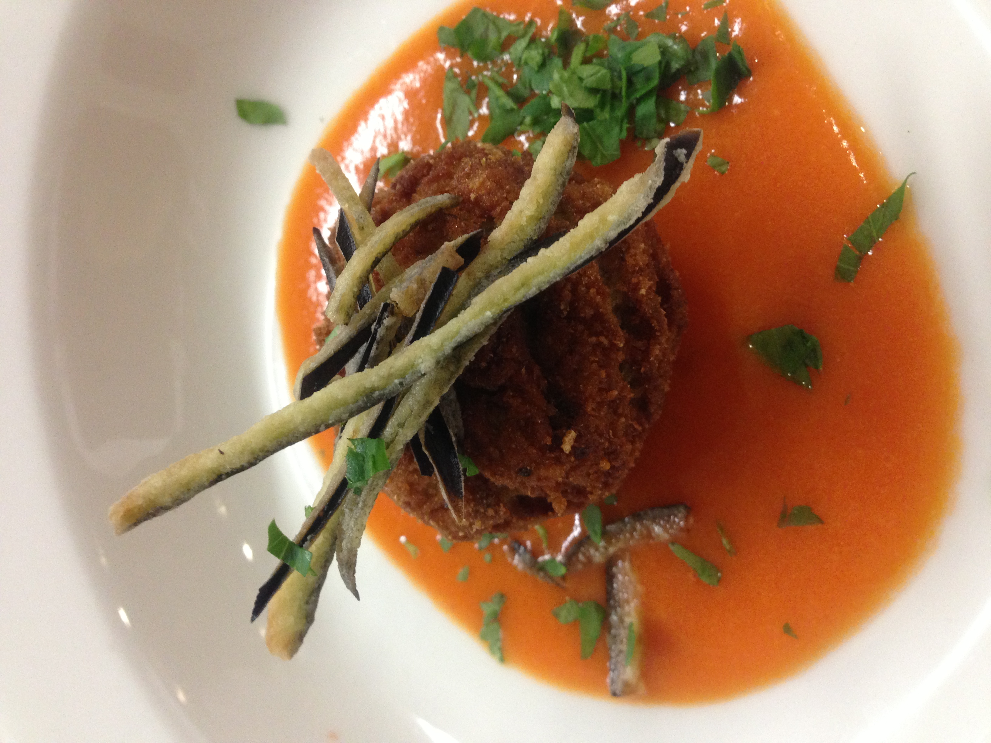 Eggplant croquettes on red bell pepper coulis