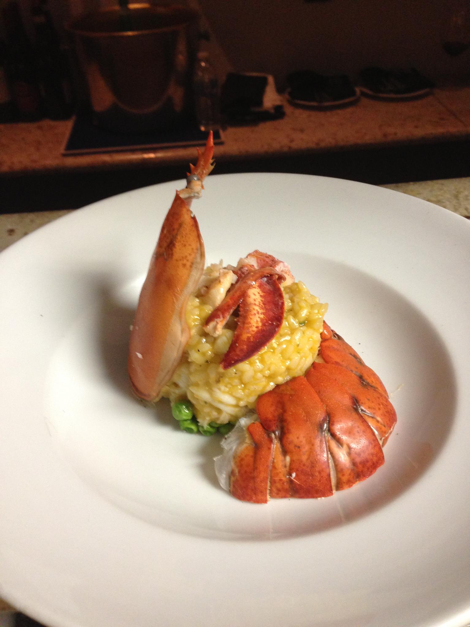 Creamy lobster risotto plated with lobster claw garnish