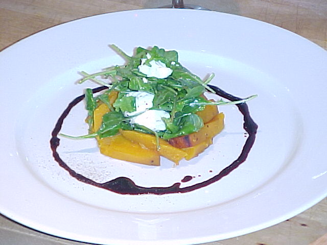 Warm roasted pumpkin salad with arugula, goat cheese, and balsamic glaze