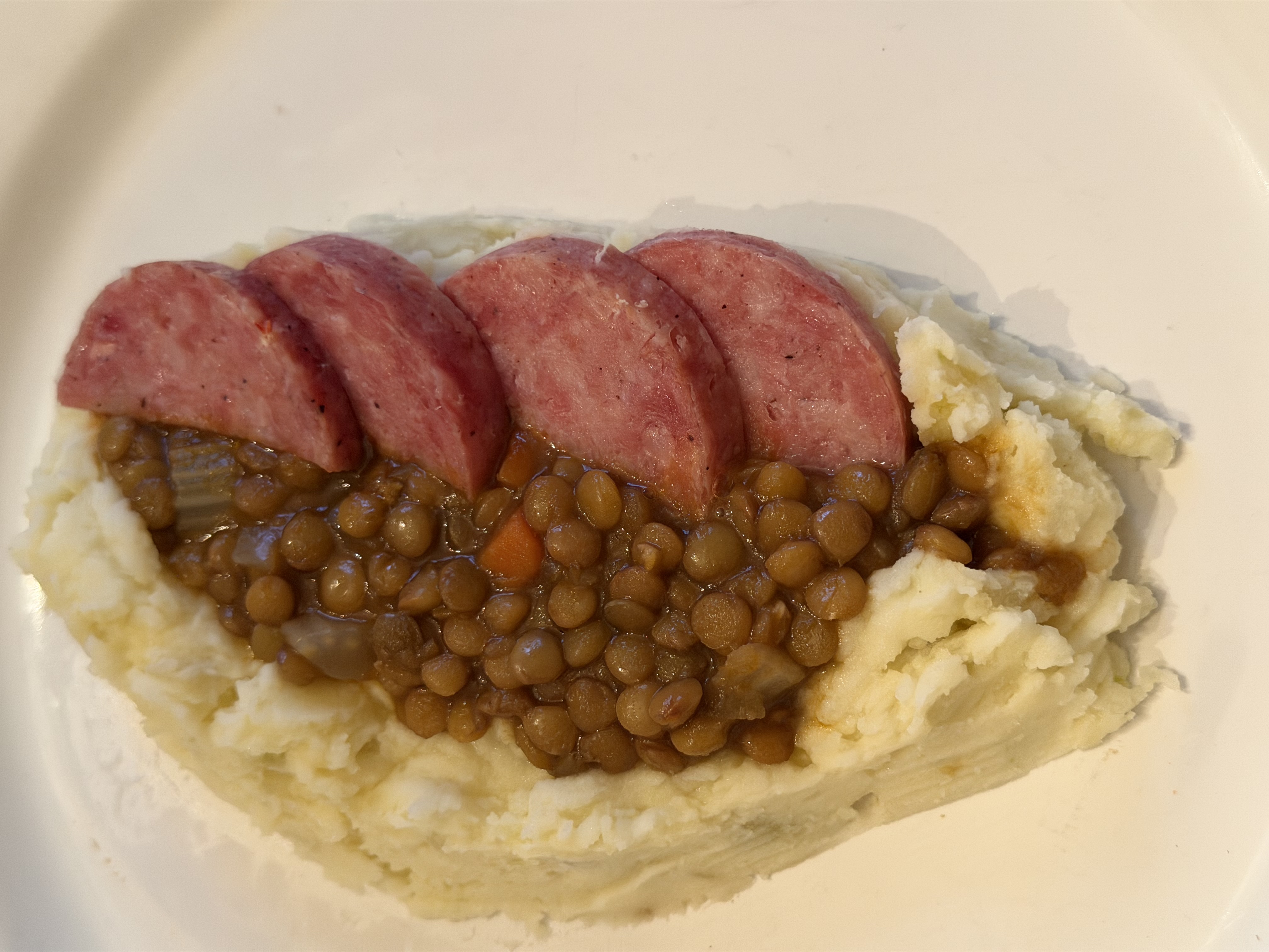 Tuscan Cotechino con Lenticchie served with mashed potatoes