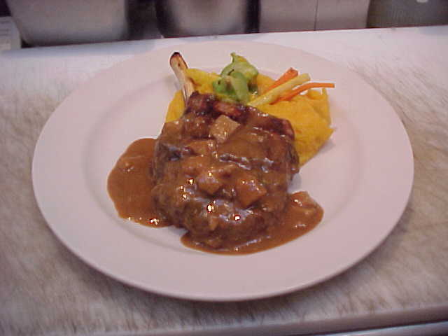 Sautéed veal chop with porcini whiskey sauce, butternut squash purée, and vegetables