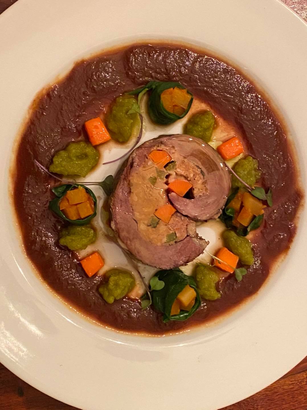 Florentine beef roulade slices with Chianti reduction and vegetable garnishes