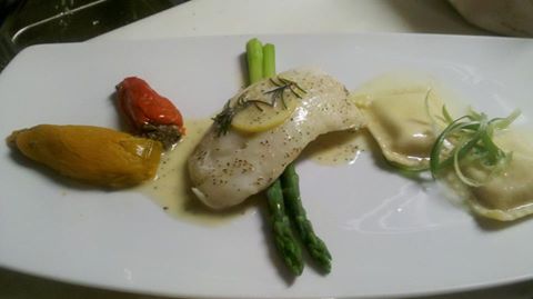 Sous vide cod filet with lemon butter, potato ravioli, stuffed baby peppers, and asparagus